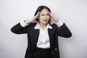 A portrait of an Asian business woman wearing a black suit isolated by white background looks depressed photo