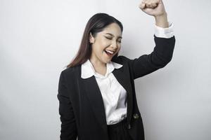 A young Asian businesswoman with a happy successful expression wearing black suit isolated by white background photo