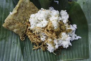 A portrait of Balinese food called Nasi Jinggo on banana leaf photo