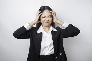 A portrait of an Asian business woman wearing a black suit isolated by white background looks depressed photo