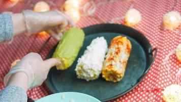 Mexican corn elote in three ways. Pressed with cheese, guacamole and pomegranate. Maxican flag video