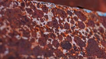 Rusty painted metal surface. Macro view of corrosion in iron metal, texture background. Smooth slow motion video