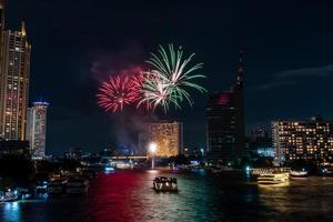 fireworks celebration on the river in the dark sky photo