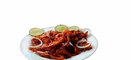 Plate of fried shrimp with onions and lemon on white background with copy space photo