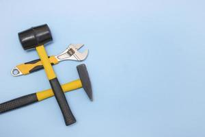 hammer, mallet, sanitary key on a light blue background with copy space photo