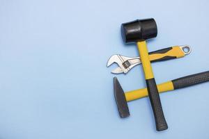 hammer, mallet, sanitary key on a light blue background with copy space photo