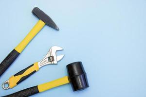 hammer, mallet, sanitary key on a light blue background with copy space photo