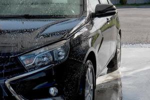 black machine in the process of washing with dripping foam photo