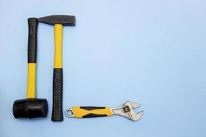 hammer, mallet, sanitary key on a light blue background with copy space photo