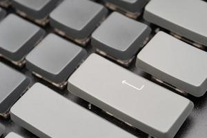 gray keyboard with enter bottom. Close up of enter button on the keyboard photo