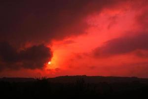 Beautiful red sunset wallpaper. Wonderful red sunset. Beautiful red sunset in the mountains wallpaper. photo