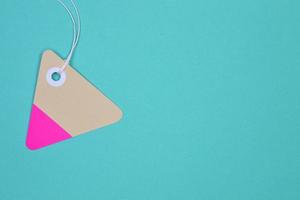 triangle paper tag on light blue background photo