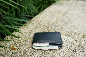 left wallet on a bench in the park photo