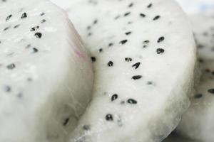 slice of dragon fruit on a chopping board. photo