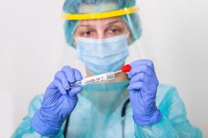 Lab technician holding swab collection kit,Coronavirus COVID-19 specimen collecting equipment,DNA nasal and oral swabbing for PCR polymerase chain reaction laboratory testing procedure and shipping photo