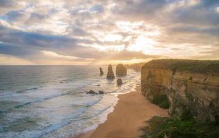 Twelve Apostle the iconic rock formation in the Great Ocean Road of Victoria state, Australia at sunset. 12 Apostles is breath-taking in splendour with its dramatic, rugged cliffs carved from the sea. photo