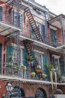 New Orleans, Louisiana, USA. November 4, 2022. An old building with fire escape ladders and ironwork balcony railings. photo