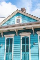 New Orleans, Louisiana, USA. November 4, 2022. A colorful blue house set against a blue sky and white clouds. photo