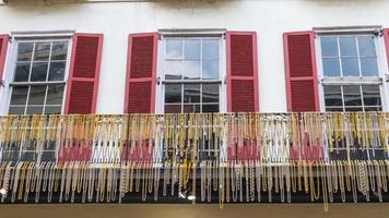 New Orleans, Louisiana, USA. November 4, 2022. A balcony in New Orleans decorated with Mardi Gras beaded necklaces. photo