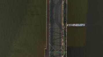 Aerial view of Phra Buddha Yodfa Bridge, Memorial Bridge with both transportation over the Chaophraya River at sunrise scene, Bangkok City, Thailand video