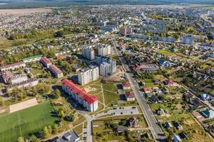 aerial panoramic view from great height of provincial town with a private sector and high-rise urban apartment buildings photo