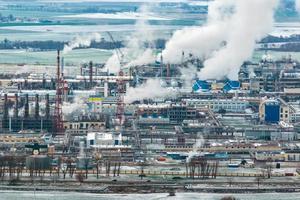 winter aerial panoramic view on smoke of pipes of chemical enterprise plant. Industrial landscape environmental pollution waste plant. Air pollution concept. photo