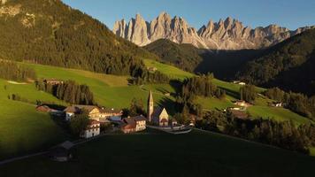 Santa Maddalena or St. Magdalena Church aerial view in Val di Funes and Odle mountain in the Dolomites, South Tyrol, Italy video
