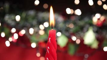 luz de vela roja para la celebración de navidad, fondo de navidad. velas de cera. video