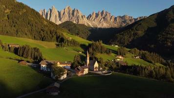 Santa Maddalena or St. Magdalena Church aerial view in Val di Funes and Odle mountain in the Dolomites, South Tyrol, Italy video