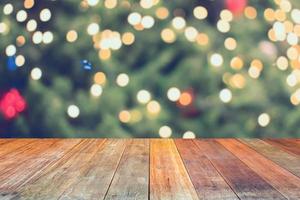 Empty wood table top with blur Christmas tree with bokeh light background photo