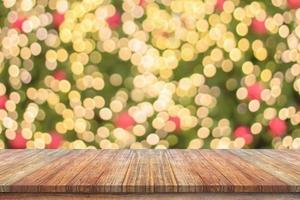 Empty wood table top with blur Christmas tree with bokeh light background photo