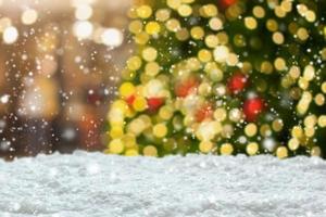 Empty white snow with blur Christmas tree with bokeh light background photo