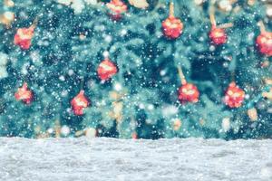 Empty white snow with blur Christmas tree with bokeh light background photo