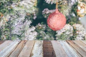 Empty wood table top with blur Christmas tree with bokeh light background photo