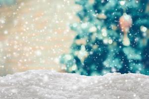 Empty white snow with blur Christmas tree with bokeh light background photo