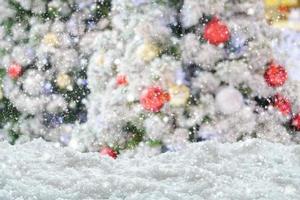 Empty white snow with blur Christmas tree with bokeh light background photo