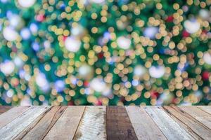 Empty wood table top with blur Christmas tree with bokeh light background photo