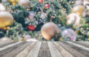 Empty wood table top with blur Christmas tree with bokeh light background photo