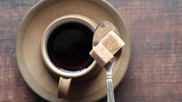Two cubes of sugar and black coffee video