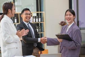 A team of business people join hands to work as a sales representative to build a profitable sales team. photo