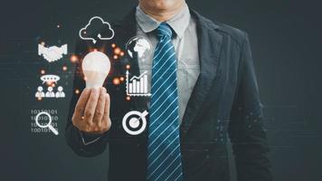 businessman Hand holding Light bulb Global Internet connection.business icons on network connection application technology and digital marketing,Digital link tech,big data,Financial and banking. photo