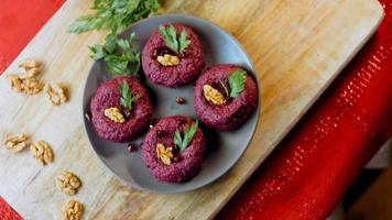 The girl tastes pkhali. Pkhali traditional Georgian food. Beetroot is used for the purple color. Walnut is used for decoration video