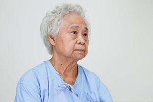 Asian elder senior woman patient sitting and smile face with happy on bed in hospital. photo