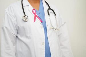 Asian woman doctor with pink ribbon, World Breast Cancer Day at October. photo