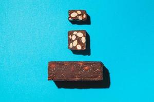 Protein date fruit candy bars fitness with nuts top view on blue background with copy space and place for text photo