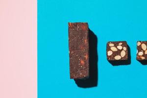 Protein date fruit candy bars fitness with nuts top view on blue background with copy space and place for text photo