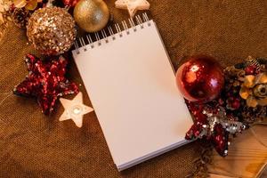 cuaderno con páginas en blanco con juguetes, regalos y números de año nuevo 2023. planes y sueños para el nuevo año, espacio para texto foto