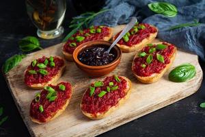 Bruschetta with grated beetroot, herbs and caramelized onion photo