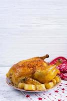 Roasted chicken and potato with Christmas decoration. Traditional food for Christmas or Thanksgiving day photo