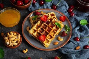 Delicious breakfast with belgian waffles. Waffels with strawberry and berry jam photo